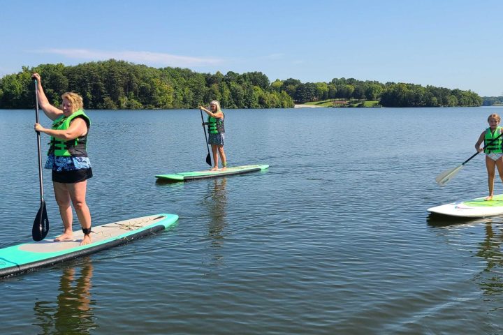 a group of people riding on the back of a boat in the water