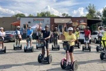 a group of people riding on top of a parking lot